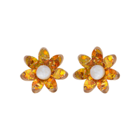 Pair of orange and gold holographic confetti flower studs with white centres side by side on white, front view