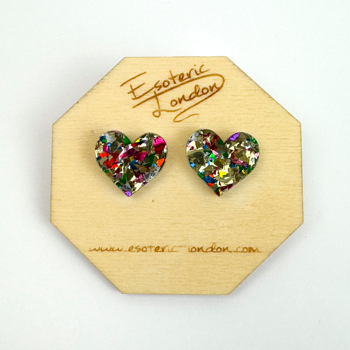 Gold confetti glitter heart stud earrings with multicoloured flecks on an octagonal wooden backing card