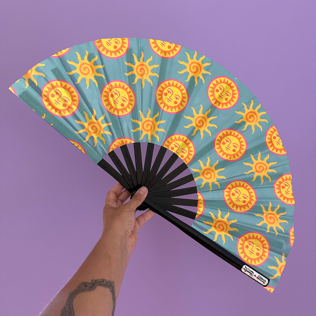 Giant Clacking Hand Fan with Sun Faces Teal print (Glows in UV!)