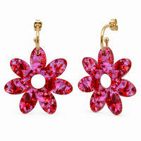 Pair of pink and red holographic confetti flower dangle hoops with gold hoops, front view on white