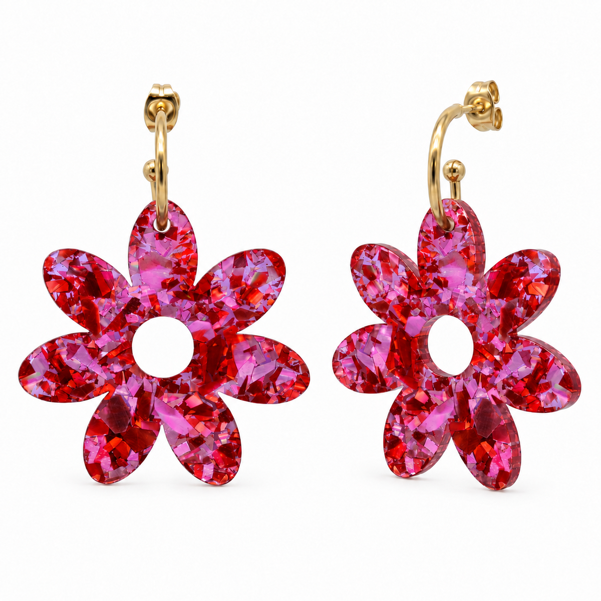 Pair of pink and red holographic confetti flower dangle hoops with gold hoops, front view on white