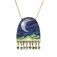 Arch pendant necklace with a sleeping moon, gold stars, green mountains and green bead fringe, on a gold chain