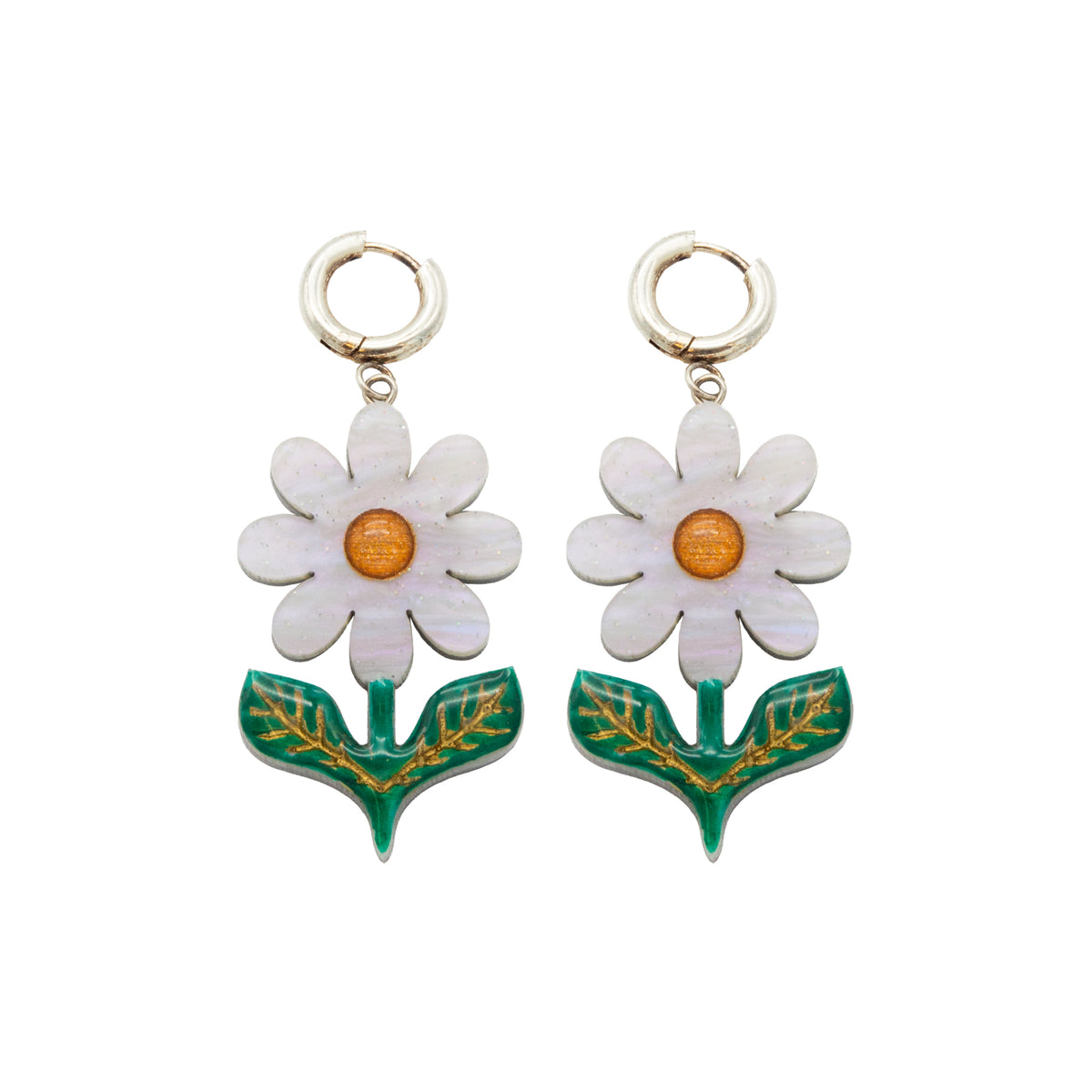 Moonlight white daisy dangle earrings with orange centres and green gold-etched leaves on a white background