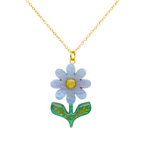 Sky blue pearlescent acrylic daisy pendant with gold glitter centre and green leaves, on a gold chain, on white