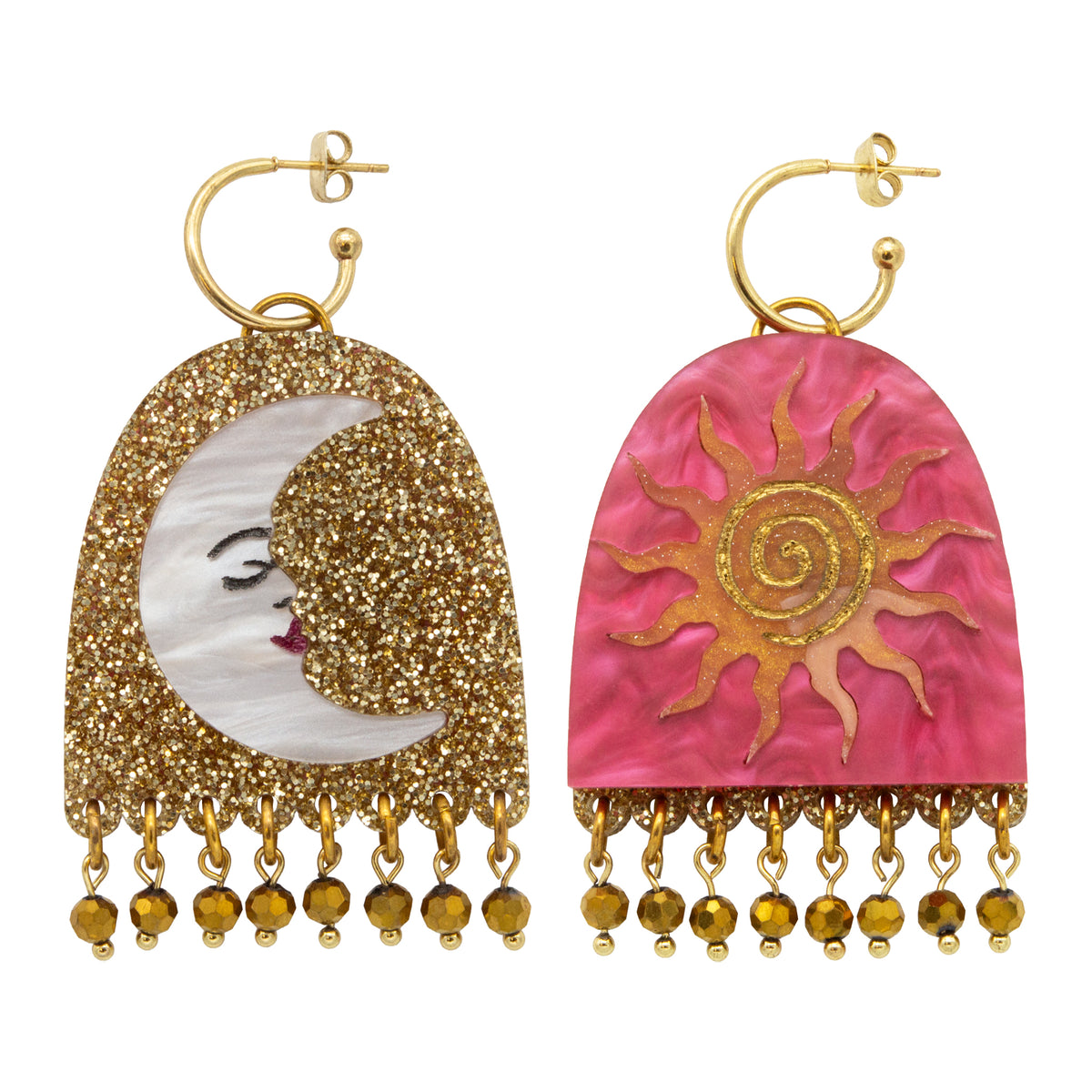 Mismatched arch hoop earrings, one gold glitter moon face and one pink pearl sun, each with gold bead fringe