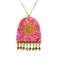Pink pearlescent arch pendant with orange sun and gold spiral, gold bead fringe, on a gold chain