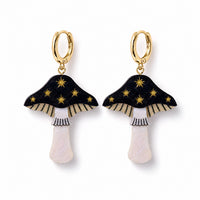 Black acrylic toadstool earrings with gold star detail, cream gills and pearly white stems on gold huggie hoops