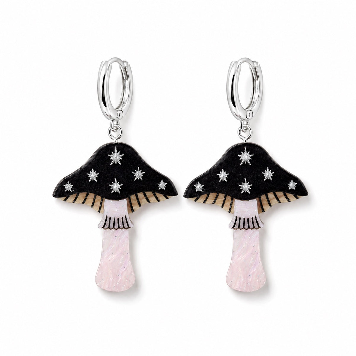 Black toadstool earrings with silver star details, striped gills and pearly pale pink stems on silver huggie hoops