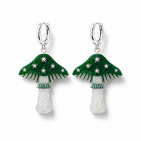 Green toadstool earrings with silver stars, striped gills and pearly white stems on silver huggie hoops