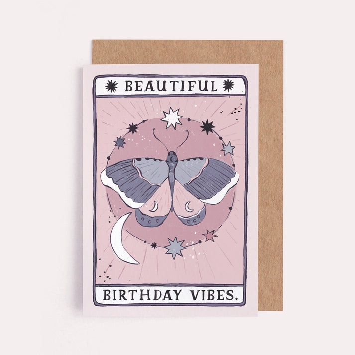 Birthday card with a lilac and pink moth, crescent moon and stars in a tarot style frame, with a kraft envelope
