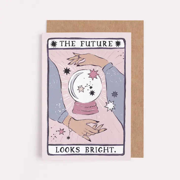 The Future Looks Bright card showing hands around a crystal ball with stars, in pinks and lilac, with kraft envelope