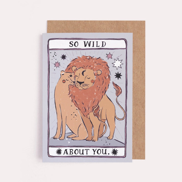So Wild About You card with a lion and lioness nuzzling on a lilac tarot style background, with kraft envelope